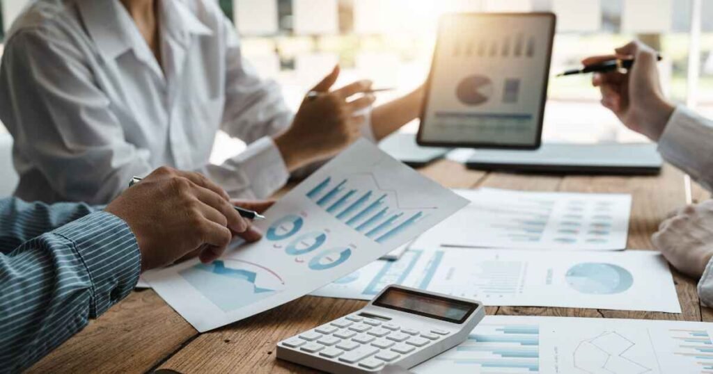 Consultants reviewing charts, graphs, and AI performance data during a business strategy meeting