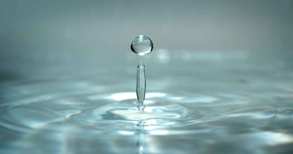 Image of a hand reaching out to press a glowing, prominent button labeled "Start Your AI ROI Measurement Now," with a spotlight effect.